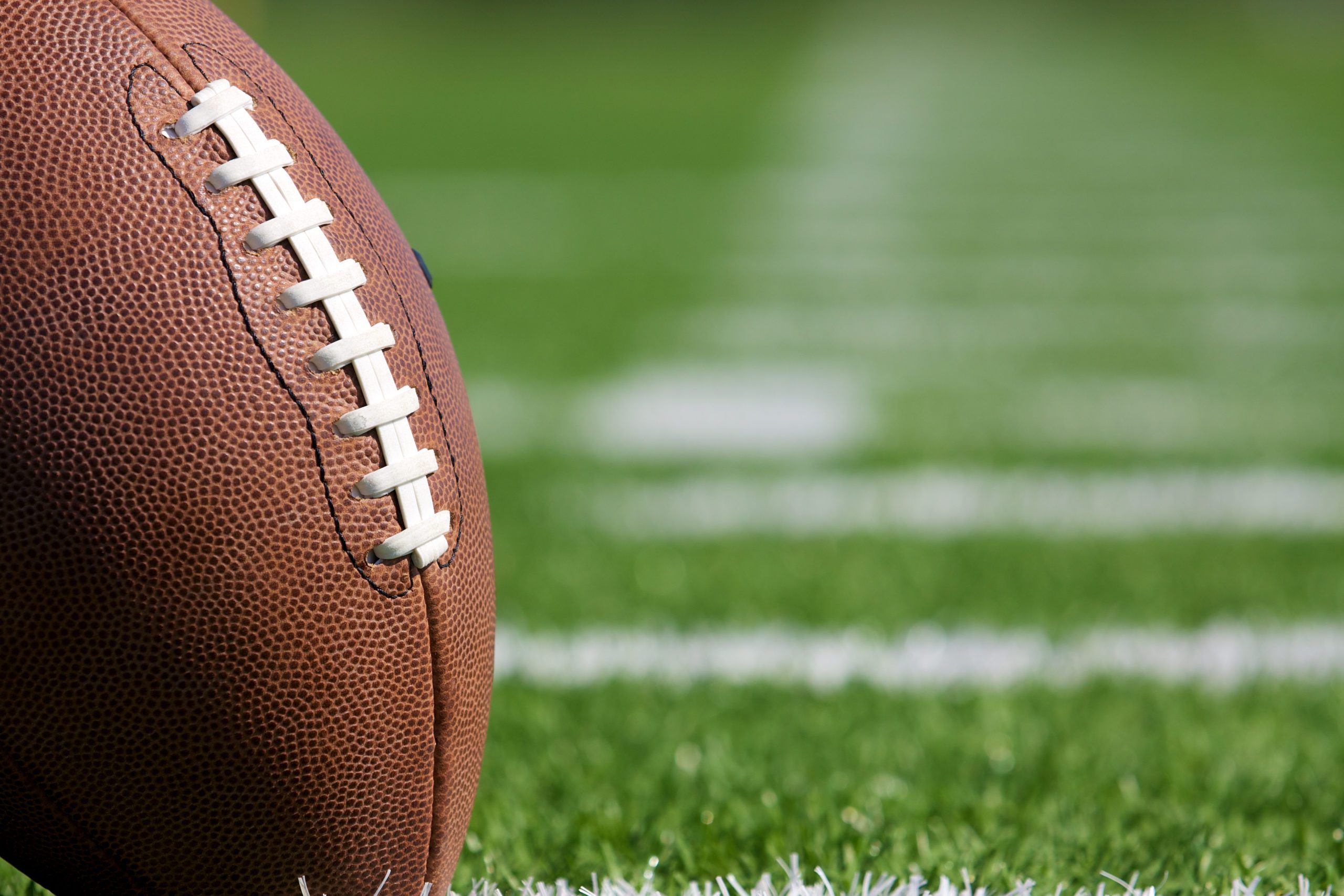 Pro American Football on the Field Close Up with room for copy, shot at shallow depth of field